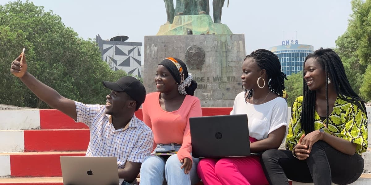 Young Nigerians using laptops together